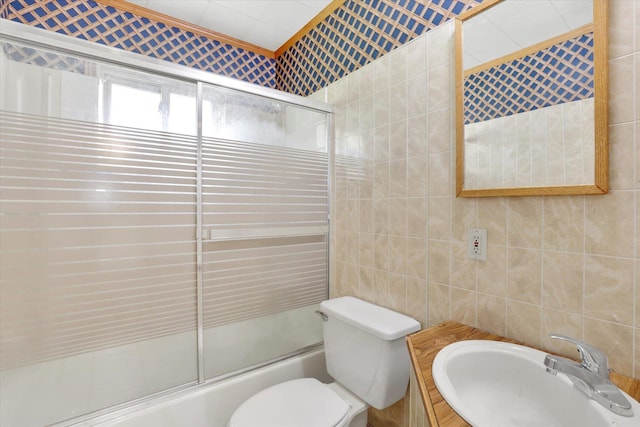 1718 E 39th Ave, Spokane, WA 99203 - bathroom featuring combined bath / shower with glass door, tile walls, and vanity