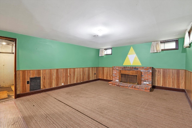1718 E 39th Ave, Spokane, WA 99203 - unfurnished living room with a fireplace, wainscoting, wood walls, and plenty of natural light