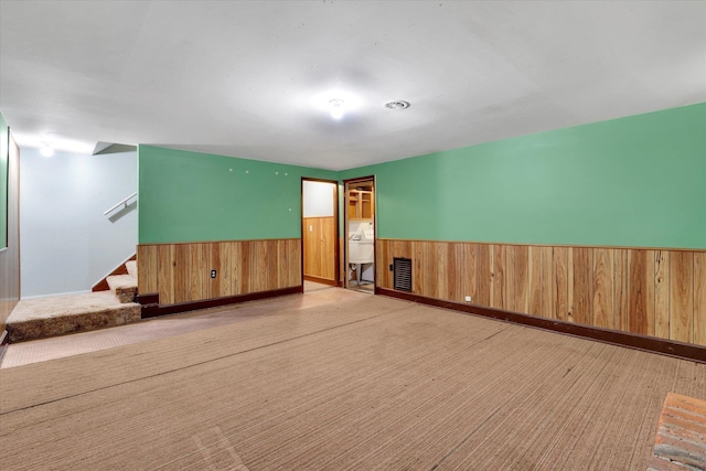 1718 E 39th Ave, Spokane, WA 99203 - carpeted empty room with wainscoting, wood walls, and stairway