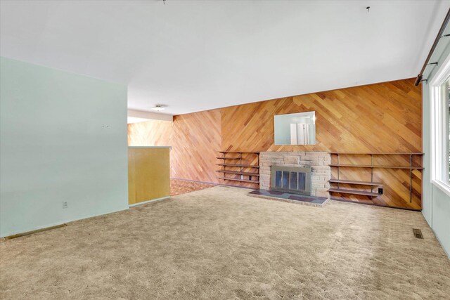 1718 E 39th Ave, Spokane, WA 99203 - unfurnished living room with wooden walls, carpet, and a glass covered fireplace