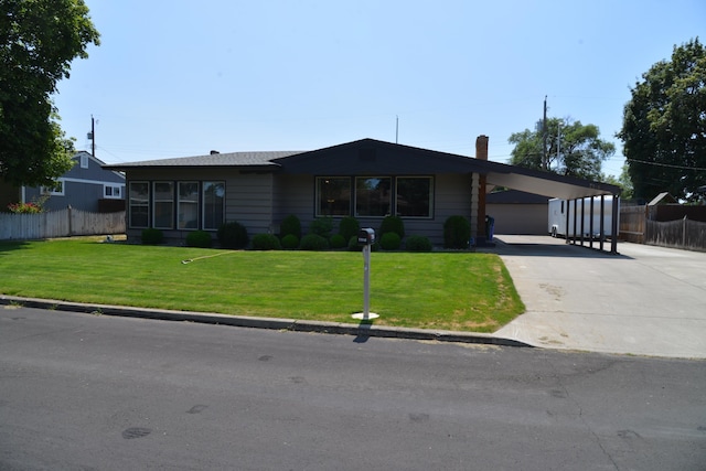 7516 E Baldwin Ave, Spokane Valley, WA 99212 - view of front of home featuring concrete driveway, a carport, and a chimney