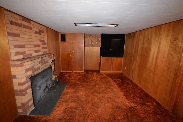 7516 E Baldwin Ave, Spokane Valley, WA 99212 - unfurnished living room with wooden walls, dark colored carpet, and a brick fireplace