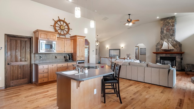19918 E Pheasant Dr, Greenacres, WA 99016 - kitchen with open floor plan, stainless steel appliances, ceiling fan, a kitchen breakfast bar, and high vaulted ceiling