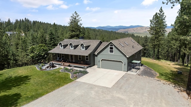 19918 E Pheasant Dr, Greenacres, WA 99016 - view of front facade featuring driveway, covered porch, a forest view, a front lawn, and a garage