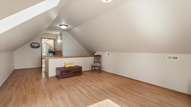 19918 E Pheasant Dr, Greenacres, WA 99016 - additional living space with light wood-style flooring, vaulted ceiling, and a skylight