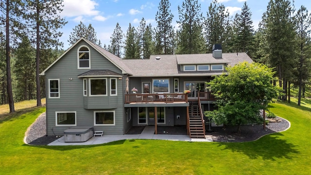 19918 E Pheasant Dr, Greenacres, WA 99016 - back of property featuring a hot tub, a patio, a wooden deck, stairs, and a lawn