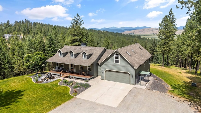 19918 E Pheasant Dr, Greenacres, WA 99016 - cape cod-style house with a forest view, a porch, concrete driveway, a front lawn, and a mountain view