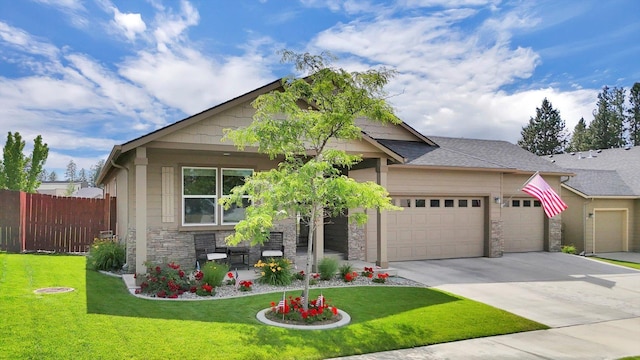 2204 S Lloyd Ct, Spokane, WA 99223 - view of front facade with stone siding, an attached garage, concrete driveway, and covered porch