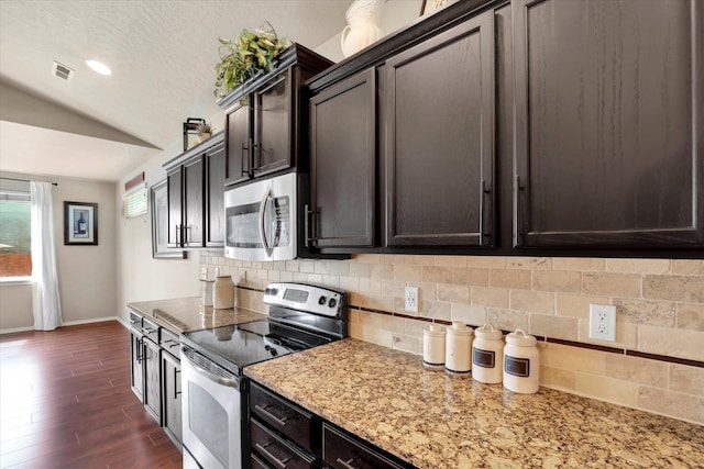 2204 S Lloyd Ct, Spokane, WA 99223 - kitchen with appliances with stainless steel finishes, lofted ceiling, tasteful backsplash, light stone counters, and dark wood-type flooring