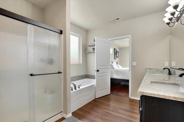 2204 S Lloyd Ct, Spokane, WA 99223 - ensuite bathroom with a shower stall, double vanity, wood finished floors, and a garden tub