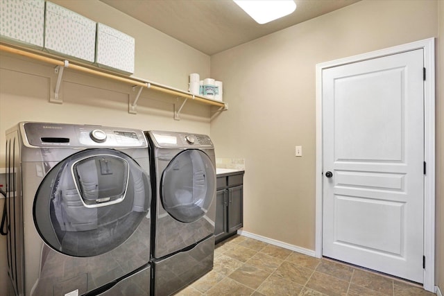 2204 S Lloyd Ct, Spokane, WA 99223 - washroom featuring separate washer and dryer, cabinet space, and light stone finish floors