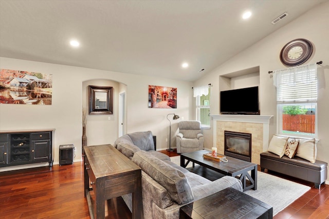2204 S Lloyd Ct, Spokane, WA 99223 - living room with arched walkways, vaulted ceiling, a tile fireplace, recessed lighting, and dark wood-style floors