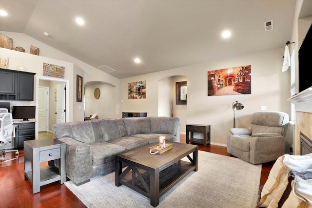 2204 S Lloyd Ct, Spokane, WA 99223 - living room with arched walkways, dark wood-style floors, a glass covered fireplace, lofted ceiling, and recessed lighting