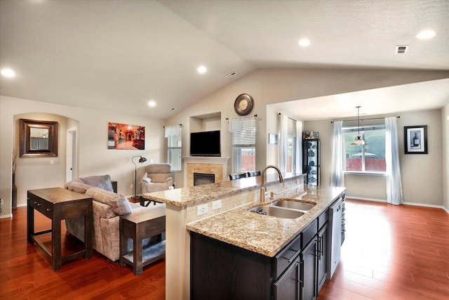 2204 S Lloyd Ct, Spokane, WA 99223 - kitchen with open floor plan, an island with sink, dark wood-type flooring, vaulted ceiling, and a fireplace