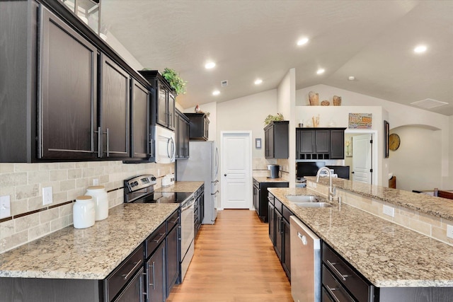2204 S Lloyd Ct, Spokane, WA 99223 - kitchen featuring stainless steel appliances, a spacious island, lofted ceiling, light wood finished floors, and light stone countertops