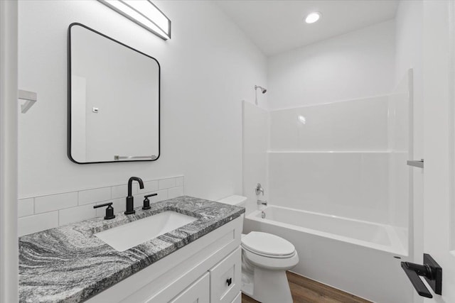 2236 E 4th Ave, Spokane, WA 99202 - full bathroom featuring vanity, tub / shower combination, wood finished floors, and backsplash