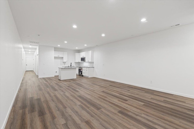2236 E 4th Ave, Spokane, WA 99202 - unfurnished living room with wood finished floors and recessed lighting