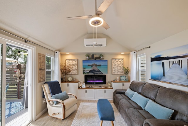 23632 E Beach Ln, Newman Lake, WA 99025 - living area featuring a wall mounted AC, lofted ceiling, light wood-style floors, a glass covered fireplace, and ceiling fan
