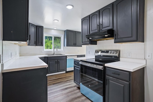 1541 Thompson Rd, Elk, WA 99009 - kitchen featuring stainless steel electric range, dishwasher, under cabinet range hood, wood finished floors, and tasteful backsplash