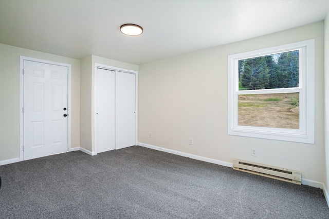 1541 Thompson Rd, Elk, WA 99009 - unfurnished bedroom with a baseboard heating unit, dark colored carpet, and a closet