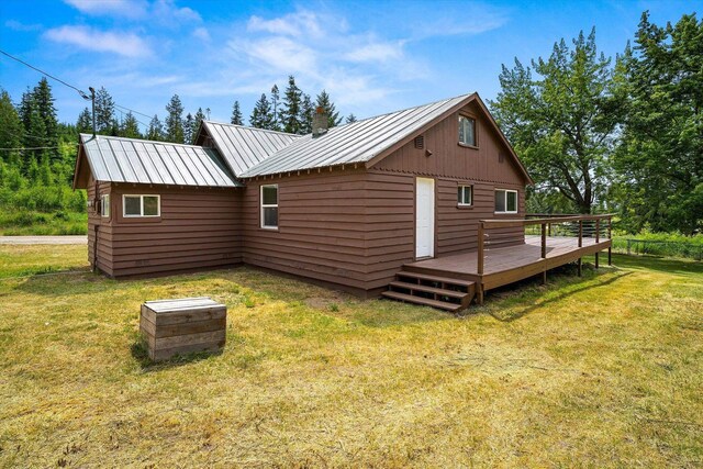 1541 Thompson Rd, Elk, WA 99009 - view of property exterior featuring a wooden deck, a yard, a metal roof, and a chimney