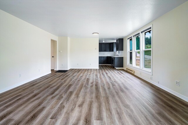 1541 Thompson Rd, Elk, WA 99009 - unfurnished living room with dark wood finished floors and baseboard heating
