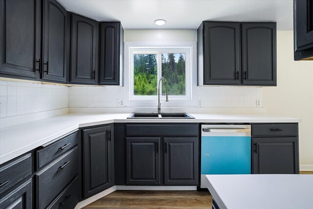 1541 Thompson Rd, Elk, WA 99009 - kitchen with dishwasher, backsplash, dark wood-style flooring, and light countertops