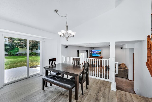 1308 S Drummond Rd, Spokane Valley, WA 99016 - dining room featuring light wood-type flooring, a chandelier, and high vaulted ceiling