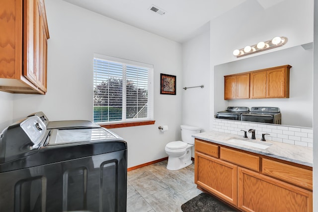 1308 S Drummond Rd, Spokane Valley, WA 99016 - bathroom with washing machine and clothes dryer and vanity