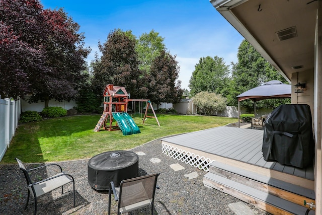 1308 S Drummond Rd, Spokane Valley, WA 99016 - fenced backyard featuring a gazebo, a fire pit, a playground, and a deck