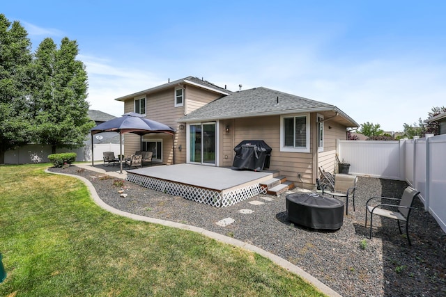 1308 S Drummond Rd, Spokane Valley, WA 99016 - back of house with a fire pit, a fenced backyard, roof with shingles, and a gazebo