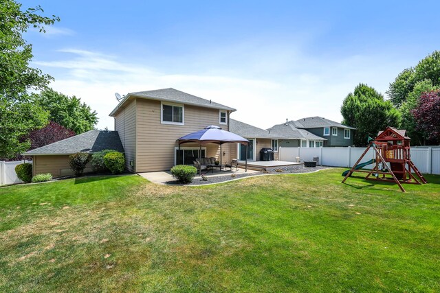1308 S Drummond Rd, Spokane Valley, WA 99016 - rear view of house with a fenced backyard, a patio, and a playground