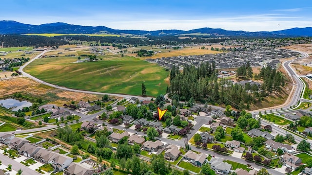 1308 S Drummond Rd, Spokane Valley, WA 99016 - aerial overview of property's location with a mountain backdrop and nearby suburban area