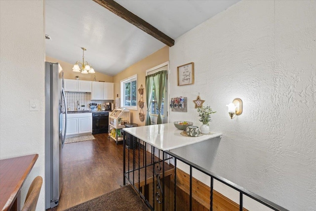 6503 N Calispel St, Spokane, WA 99208 - kitchen featuring black dishwasher, a chandelier, white cabinetry, backsplash, and freestanding refrigerator