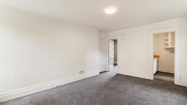 1622 W 10th Ave, Spokane, WA 99204 - unfurnished bedroom with dark carpet and baseboards