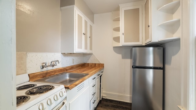 1622 W 10th Ave, Spokane, WA 99204 - kitchen with freestanding refrigerator, open shelves, white range with electric cooktop, and white cabinetry