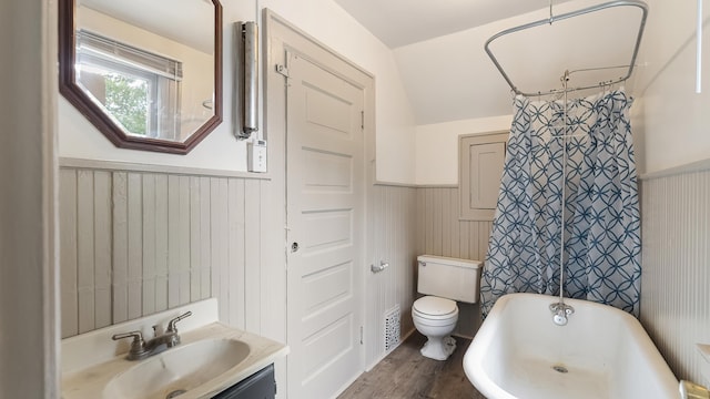 1622 W 10th Ave, Spokane, WA 99204 - bathroom featuring a wainscoted wall, wood finished floors, vanity, and vaulted ceiling