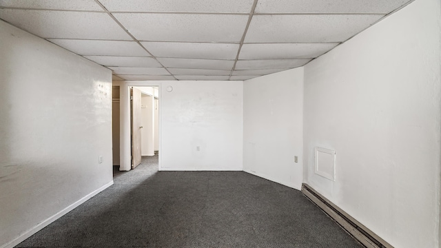1622 W 10th Ave, Spokane, WA 99204 - empty room featuring a baseboard heating unit, a drop ceiling, and carpet flooring