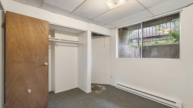 1622 W 10th Ave, Spokane, WA 99204 - unfurnished bedroom with a baseboard radiator, a drop ceiling, dark colored carpet, and a closet