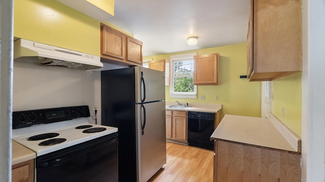 1622 W 10th Ave, Spokane, WA 99204 - kitchen featuring range with electric stovetop, dishwasher, under cabinet range hood, freestanding refrigerator, and light wood finished floors