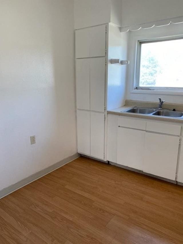 2526 W Sinto Ave, Spokane, WA 99201 - kitchen with light wood finished floors, white cabinets, and light countertops