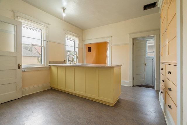 2624 W College Ave, Spokane, WA 99201 - kitchen featuring a peninsula, finished concrete flooring, and light countertops
