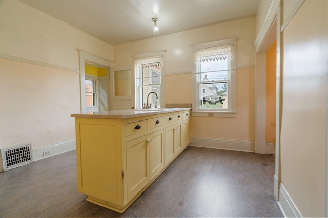 2624 W College Ave, Spokane, WA 99201 - kitchen with dark flooring, light countertops, and cream cabinetry