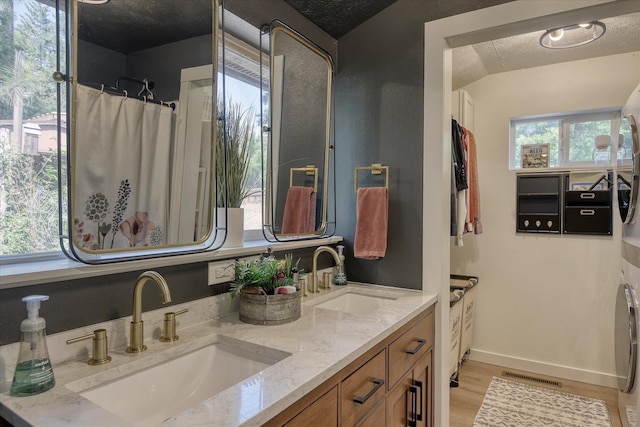 33348 Lakeview Ln, Valley, WA 99181 - full bath with double vanity, wood finished floors, and a textured ceiling