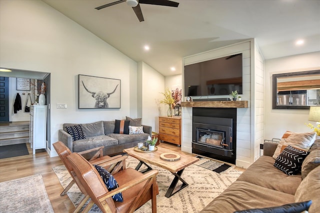33348 Lakeview Ln, Valley, WA 99181 - living area featuring wood finished floors, a ceiling fan, a glass covered fireplace, stairs, and recessed lighting