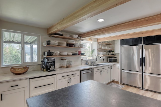 33348 Lakeview Ln, Valley, WA 99181 - kitchen with stainless steel appliances, open shelves, healthy amount of natural light, white cabinets, and beamed ceiling