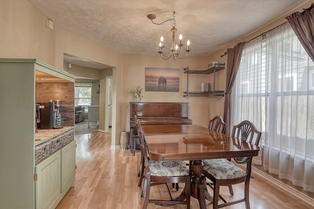 4526 N Walnut St, Spokane, WA 99205 - dining space featuring light wood-style flooring, a chandelier, and a textured ceiling
