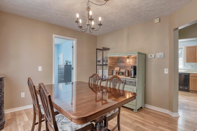 4526 N Walnut St, Spokane, WA 99205 - dining room featuring a chandelier, light wood-type flooring, and a textured ceiling
