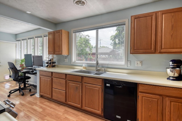 4526 N Walnut St, Spokane, WA 99205 - kitchen with black dishwasher, a textured ceiling, plenty of natural light, light countertops, and brown cabinetry