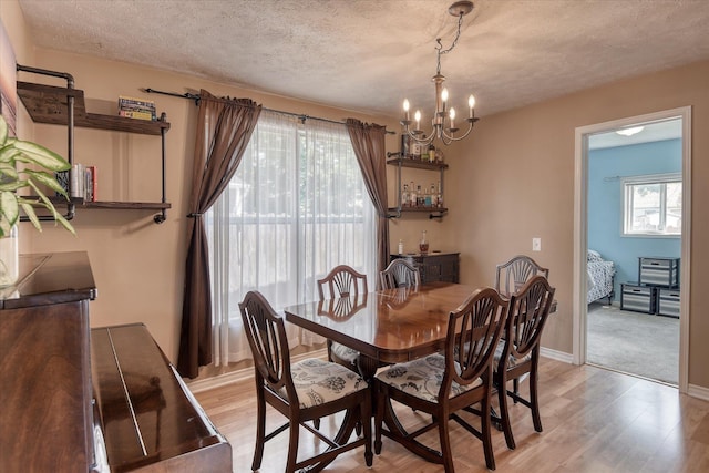 4526 N Walnut St, Spokane, WA 99205 - dining room featuring a chandelier, a textured ceiling, and light wood-style floors